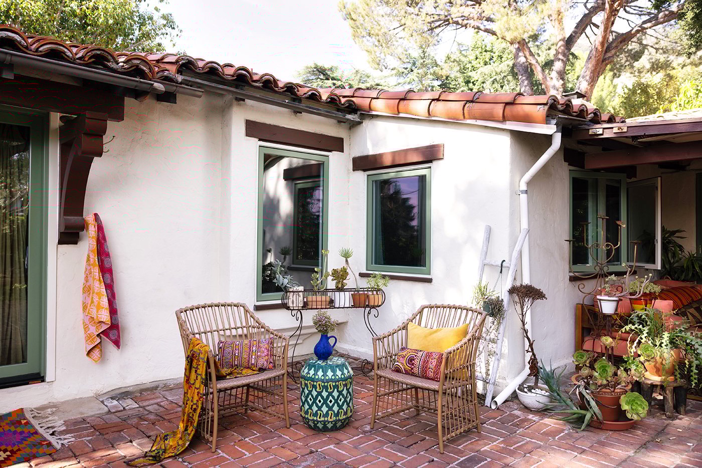 A Spanish-style home with a tile roof and olive green Andersen E-Series windows and doors