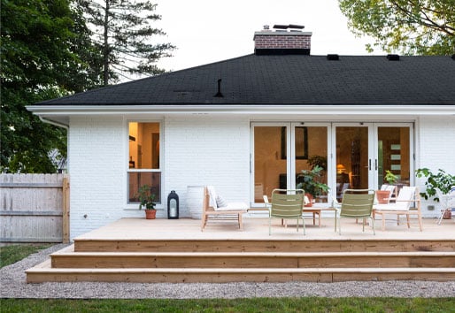 exterior view of white house with deck