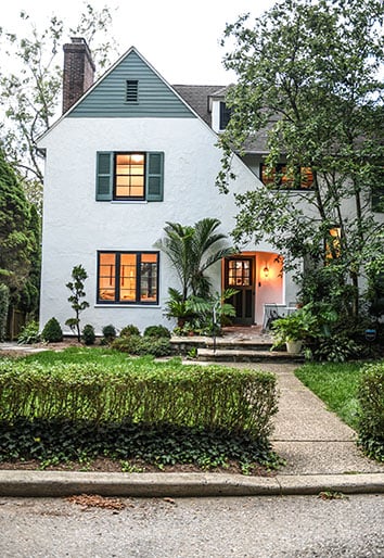 Exterior of Hilton Carter's 1916 renovated home, white with blue details