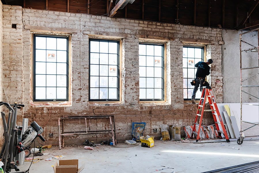 interior of brick house with natural light coming through black framed andersen windows