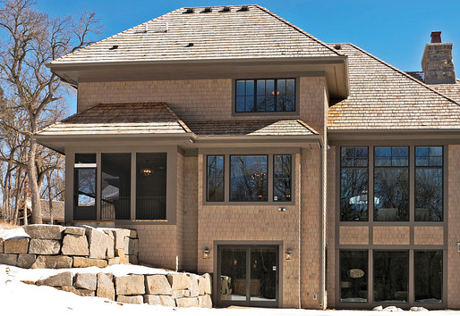 Exterior of brown house with Andersen vinyl windows and patio doors