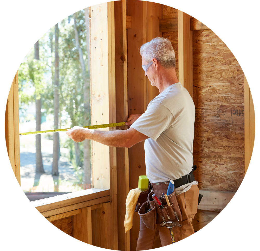 Contractor measuring a rough opening